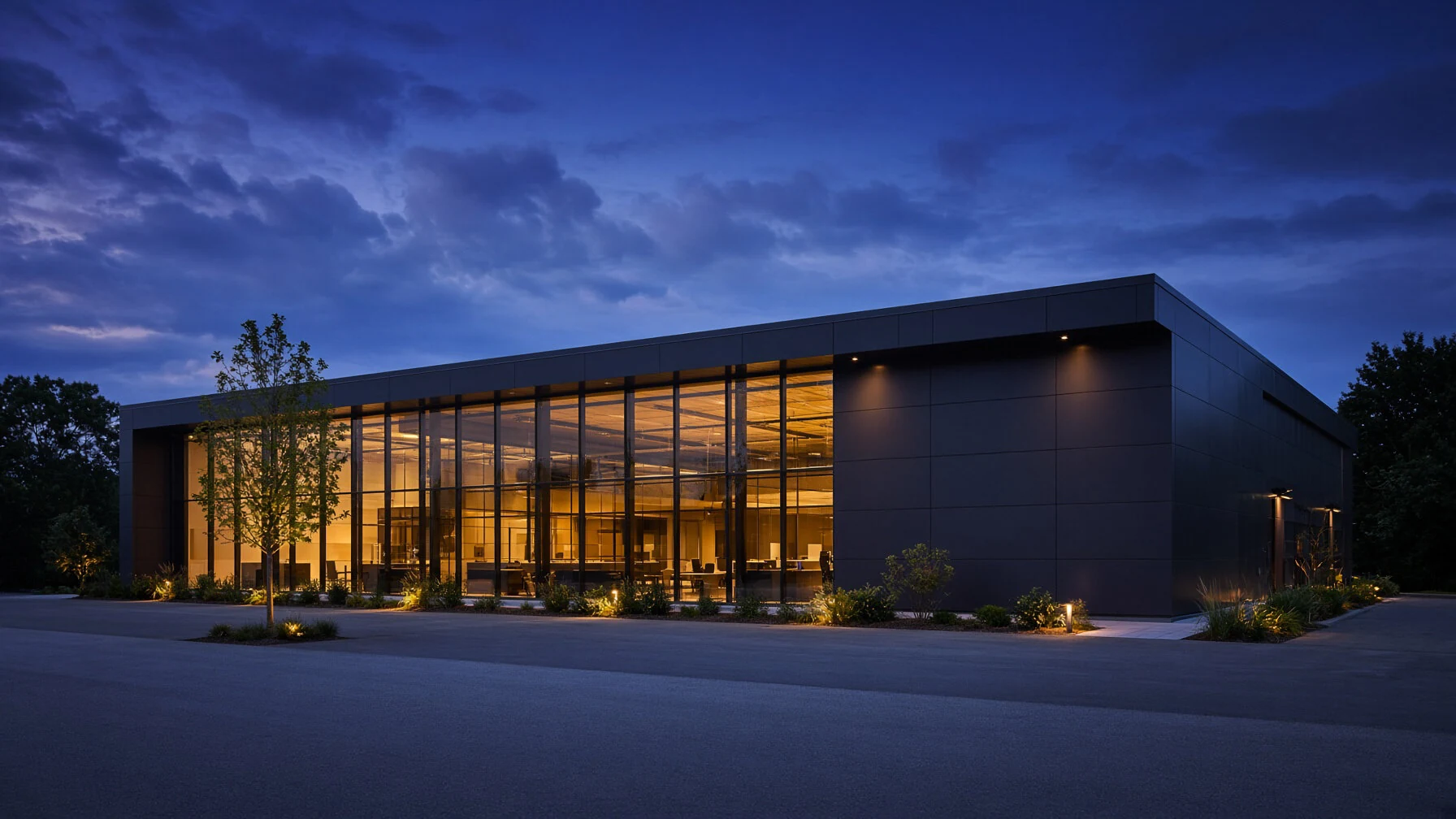 A commercial pavilion illuminated at dusk.